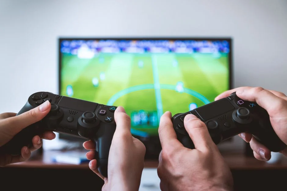Ilustrasi konsol PlayStation dengan game digital di layar