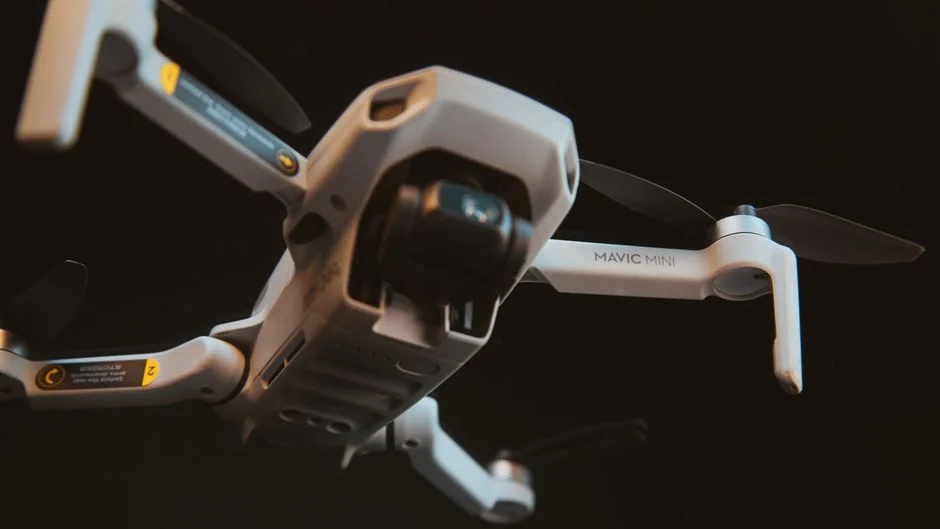 DJI Mini 5 Pro terbang di atas pemandangan alam.